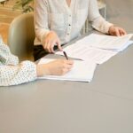 Client reviewing financial documents with legal counsel